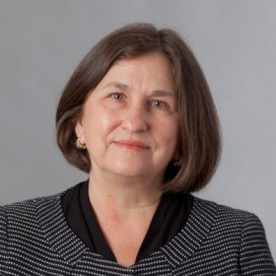 A headshot of Cynthia Baldwin against a gray background.